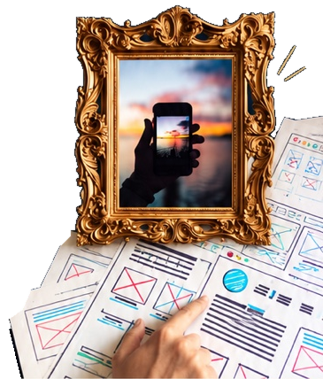 A gold-framed photograph of a hand holding a phone, alongside paper interface sketches and a hand exploring them.